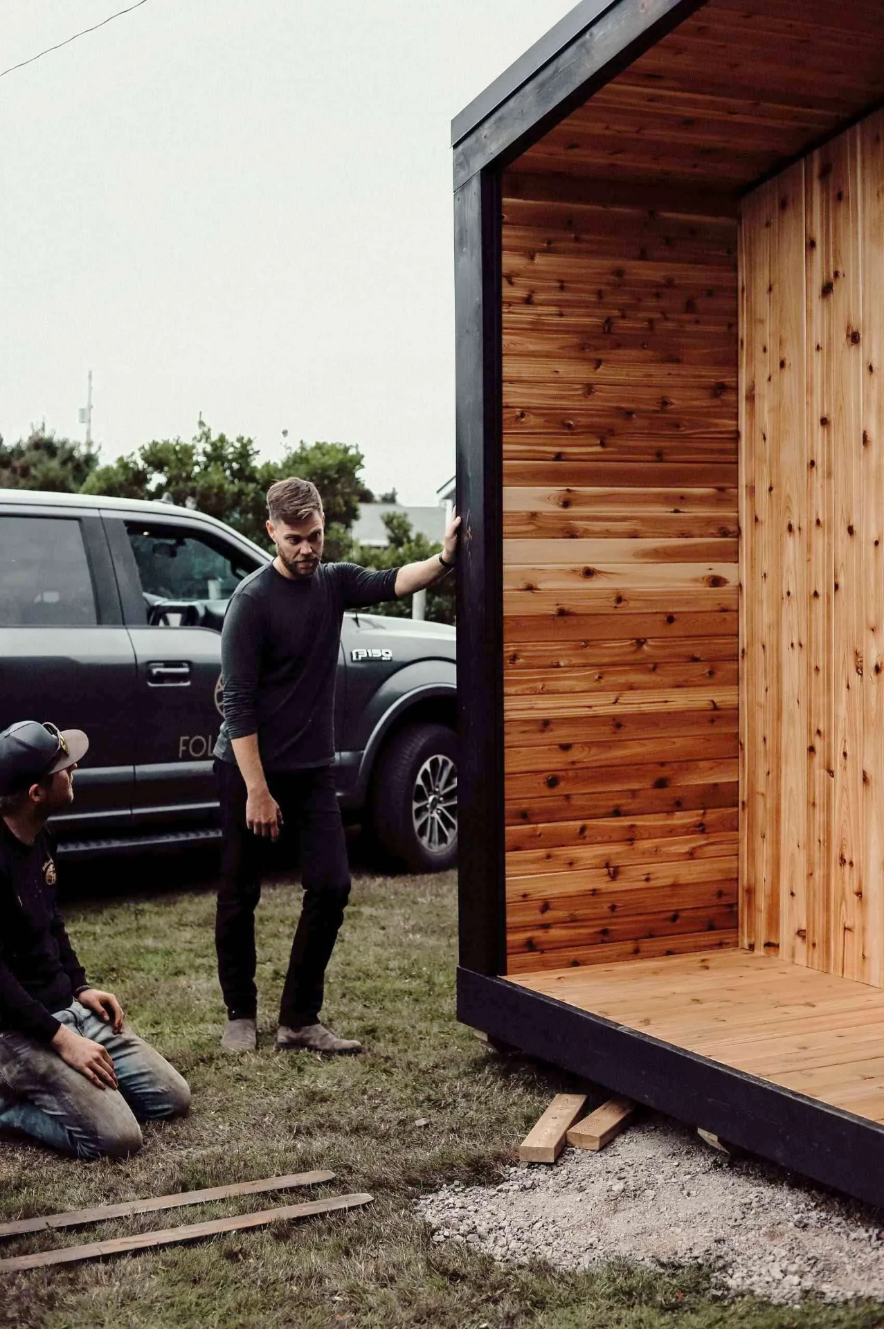 Craftsman planing a cedar sauna bench in a workshop