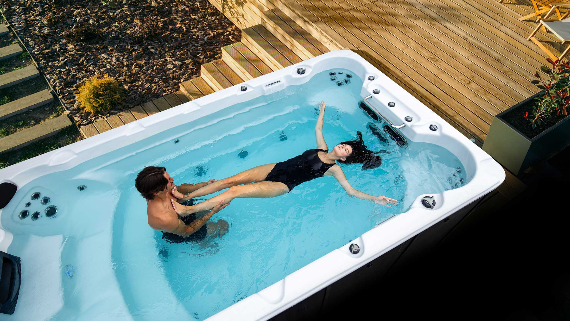 Couple relaxing in a North Stream swim spa